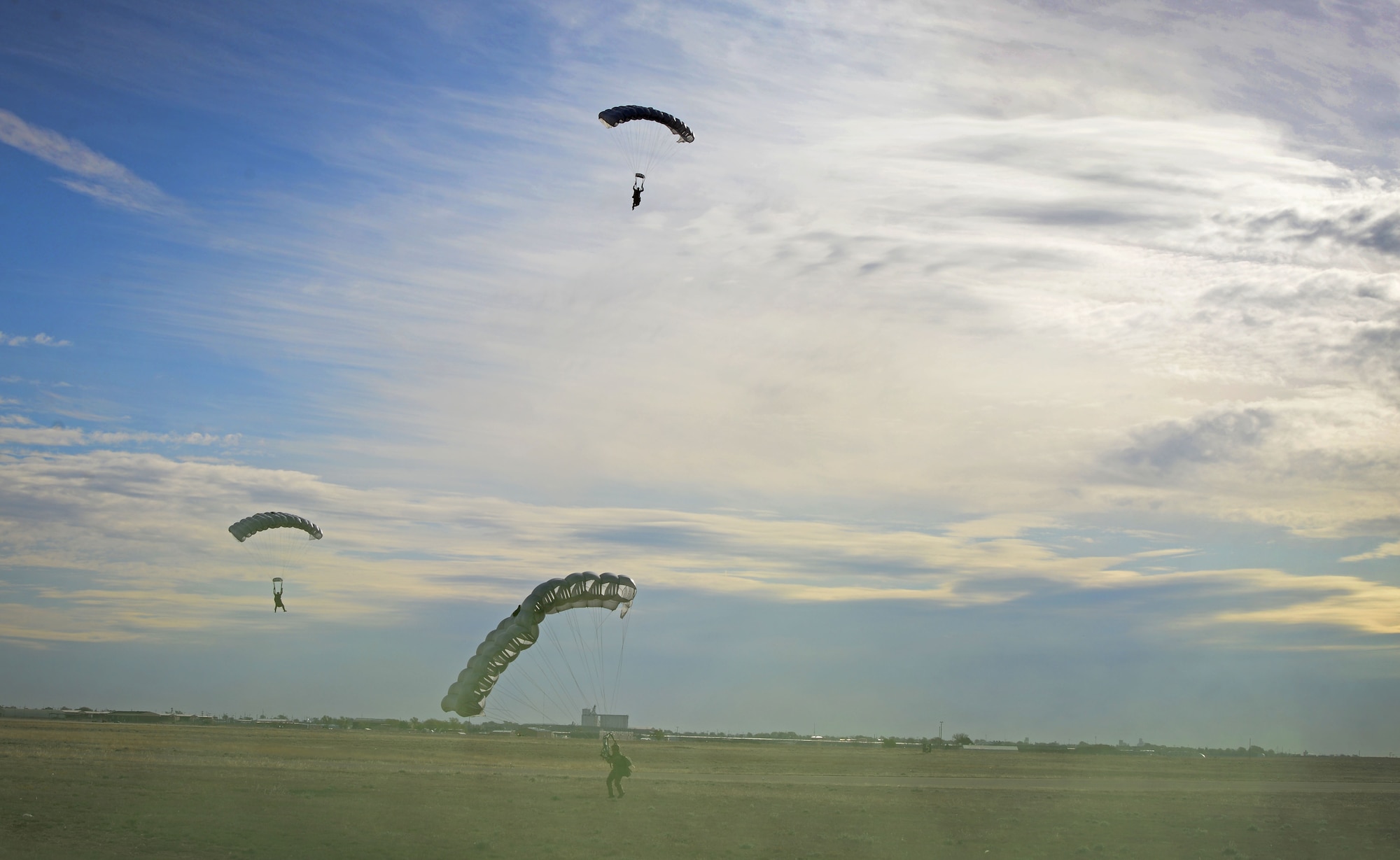 Several 26th Special Tactics Squadron members approach their final touch-down onto a landing zone March 25, 2016, at Cannon Air Force Base, N.M. Air Commandos with the 26th STS performed routine practice jumps as part of maintaining operational readiness. (U.S. Air Force photo/Staff Sgt. Alexx Pons) 