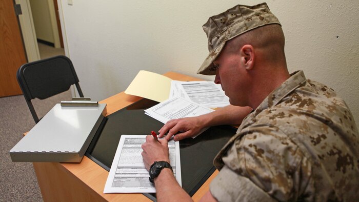 2nd Lt. James Whitcher, a student at the Marine Military Police Officer Basic Course, goes through incident reports during the Watch Officer Exercise at Fort Leonard Wood, Missouri, March 28, 2016.  The Watch Officer Exercise was the culminating event for all the training the students have gone through during the course.  