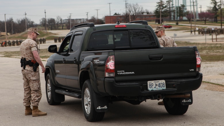 2nd Lt. Mark Crum (left) and 2nd Lt. Matthew Brattain (right), students at the Marine Military Police Officer Basic Course, conduct a traffic stop during the Watch Officer Exercise at Fort Leonard Wood, Missouri, March 24, 2016. The Watch Officer Exercise is meant to simulate the daily duties at a provost marshal office and geared toward garrison law enforcement.