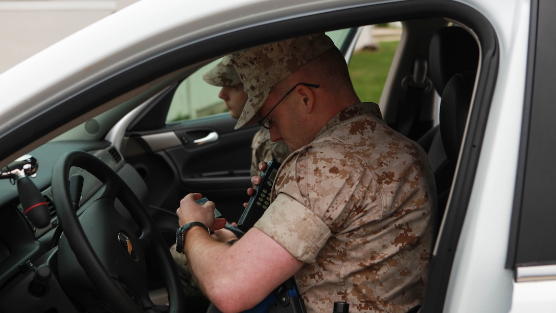 2nd Lt. Mark Crum, a student at the Marine Military Police Officer Basic Course, runs the driver license of the person he and his partner pulled over through dispatch during the Watch Officer Exercise at Fort Leonard Wood, Missouri, March 24, 2016. The Watch Officer Exercise is meant to simulate the daily duties at a provost marshal office and geared toward garrison law enforcement.   