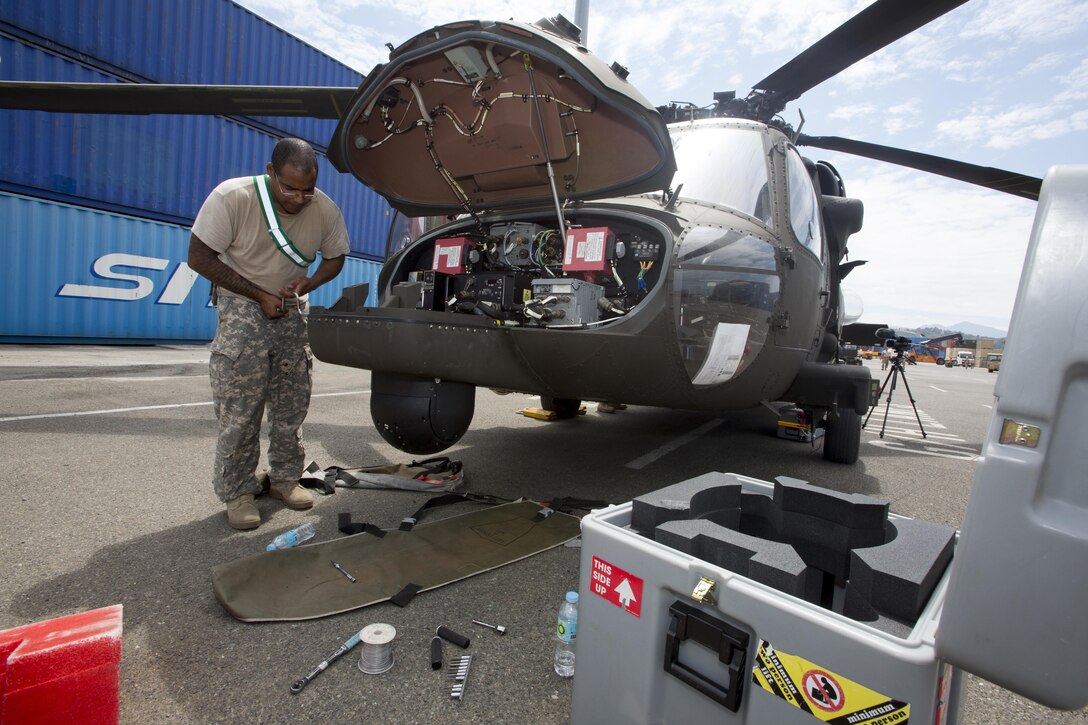 Army Sgt. Edward J. Quinones conducts maintenance on an Army HH-60 M Medical Evacuation helicopter for Balikatan 2016 in Subic Bay, Philippines, April 2, 2016. Marine Corps photo by Lance Cpl. Damon A. Mclean