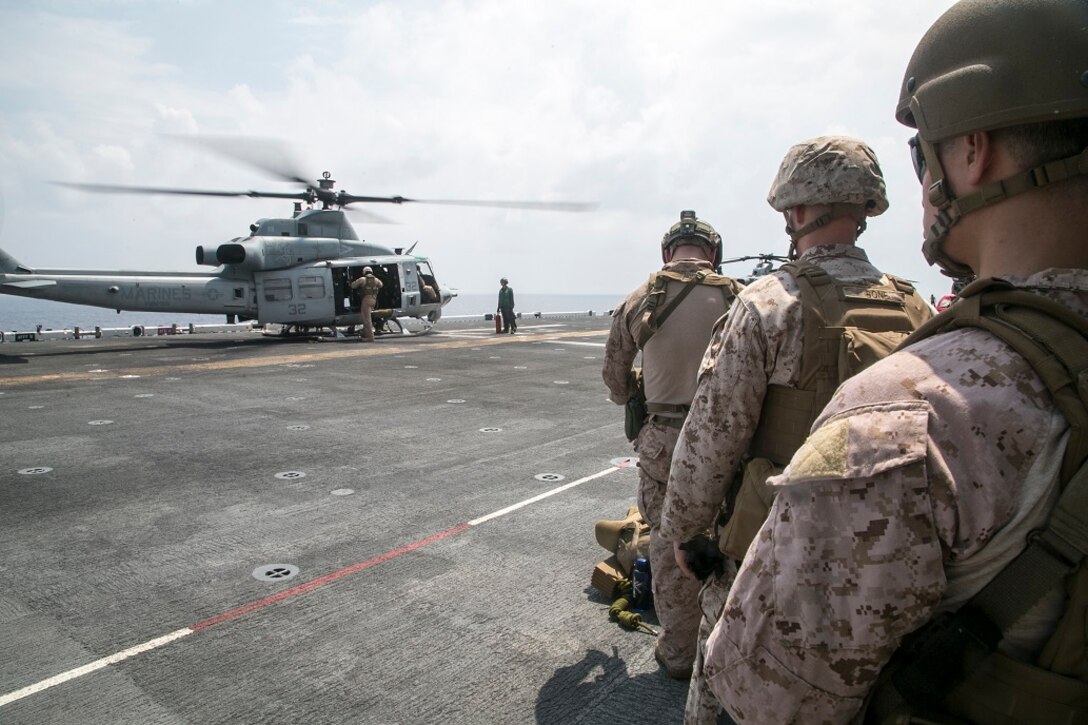 AT SEA (April 1, 2016)-U.S. Marines with the 13th Marine Expeditionary Unit, wait as planes are prepped for rappel training, April 1, 2016, during the MEU's western pacific deployment aboard the USS Boxer. More then 4,500 Marines and Sailors from the Boxer ARG, 13th MEU team are currently transiting the Pacific Ocean toward the U.S. 5th fleet area of operations during a scheduled deployment. (U.S. Marine Corps photo by Sgt. Briauna Birl/RELEASED)