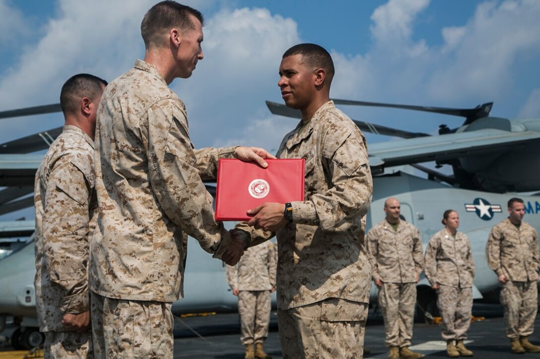 AT SEA (April 1, 2016)-U.S. Marine Sgt. Luis Cabrera Ramirez with the 13th Marine Expeditionary Unit, receives a certificate of commendation during a promotion and awards ceremony, April 1, 2016, during the MEU's western pacific deployment aboard the USS Boxer. More then 4,500 Marines and Sailors from the Boxer ARG, 13th MEU team are currently transiting the Pacific Ocean toward the U.S. 5th fleet area of operations during a scheduled deployment. (U.S. Marine Corps photo by Sgt. Briauna Birl/RELEASED)