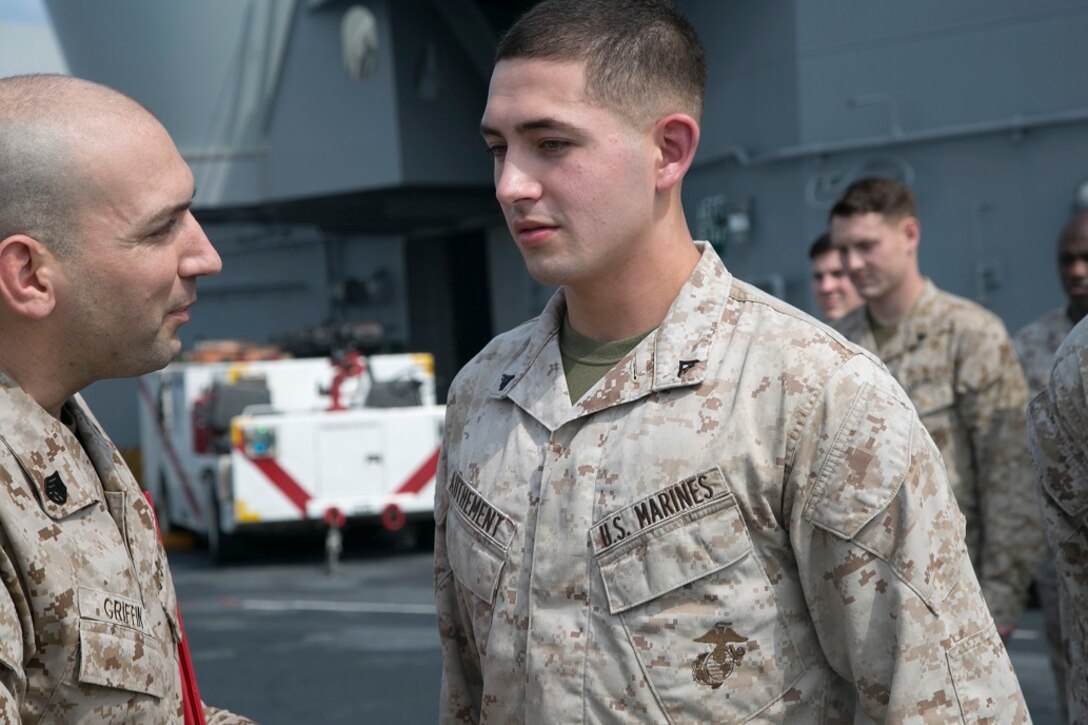 AT SEA (April 1, 2016)-U.S. Marine Cpl. Louis Authement with the 13th Marine Expeditionary Unit, receives a letter of promtion during a promotion and awards ceremony, April 1, 2016, during the MEU's western pacific deployment aboard the USS Boxer. More then 4,500 Marines and Sailors from the Boxer ARG, 13th MEU team are currently transiting the Pacific Ocean toward the U.S. 5th fleet area of operations during a scheduled deployment. (U.S. Marine Corps photo by Sgt. Briauna Birl/RELEASED)