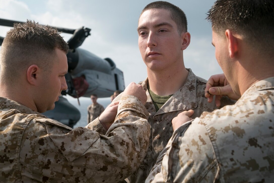 AT SEA (April 1, 2016)-U.S. Marine Lance Cpl. David Palazzolo with the 13th Marine Expeditionary Unit, is pinned with his new rank during a promotion and awards ceremony, April 1, 2016, during the MEU's western pacific deployment aboard the USS Boxer. More then 4,500 Marines and Sailors from the Boxer ARG, 13th MEU team are currently transiting the Pacific Ocean toward the U.S. 5th fleet area of operations during a scheduled deployment. (U.S. Marine Corps photo by Sgt. Briauna Birl/RELEASED)