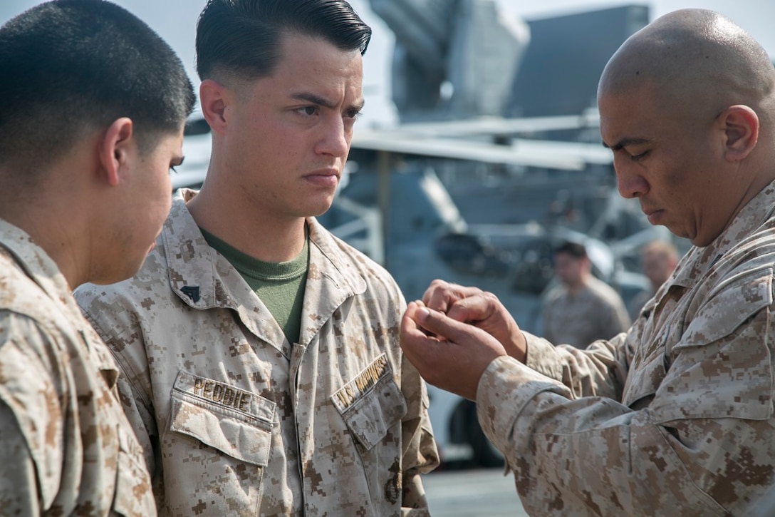 AT SEA (April 1, 2016)-U.S. Marine Sgt. Michael Peddie with the 13th Marine Expeditionary Unit, is pinned with his new rank during a promotion and awards ceremony, April 1, 2016, during the MEU's western pacific deployment aboard the USS Boxer. More then 4,500 Marines and Sailors from the Boxer ARG, 13th MEU team are currently transiting the Pacific Ocean toward the U.S. 5th fleet area of operations during a scheduled deployment. (U.S. Marine Corps photo by Sgt. Briauna Birl/RELEASED)