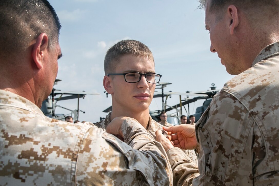 AT SEA (April 1, 2016)-U.S. Marine Lance Cpl. Clint Patenaude with the 13th Marine Expeditionary Unit, is pinned with his new rank during a promotion and awards ceremony, April 1, 2016, during the MEU's western pacific deployment aboard the USS Boxer. More then 4,500 Marines and Sailors from the Boxer ARG, 13th MEU team are currently transiting the Pacific Ocean toward the U.S. 5th fleet area of operations during a scheduled deployment. (U.S. Marine Corps photo by Sgt. Briauna Birl/RELEASED)
