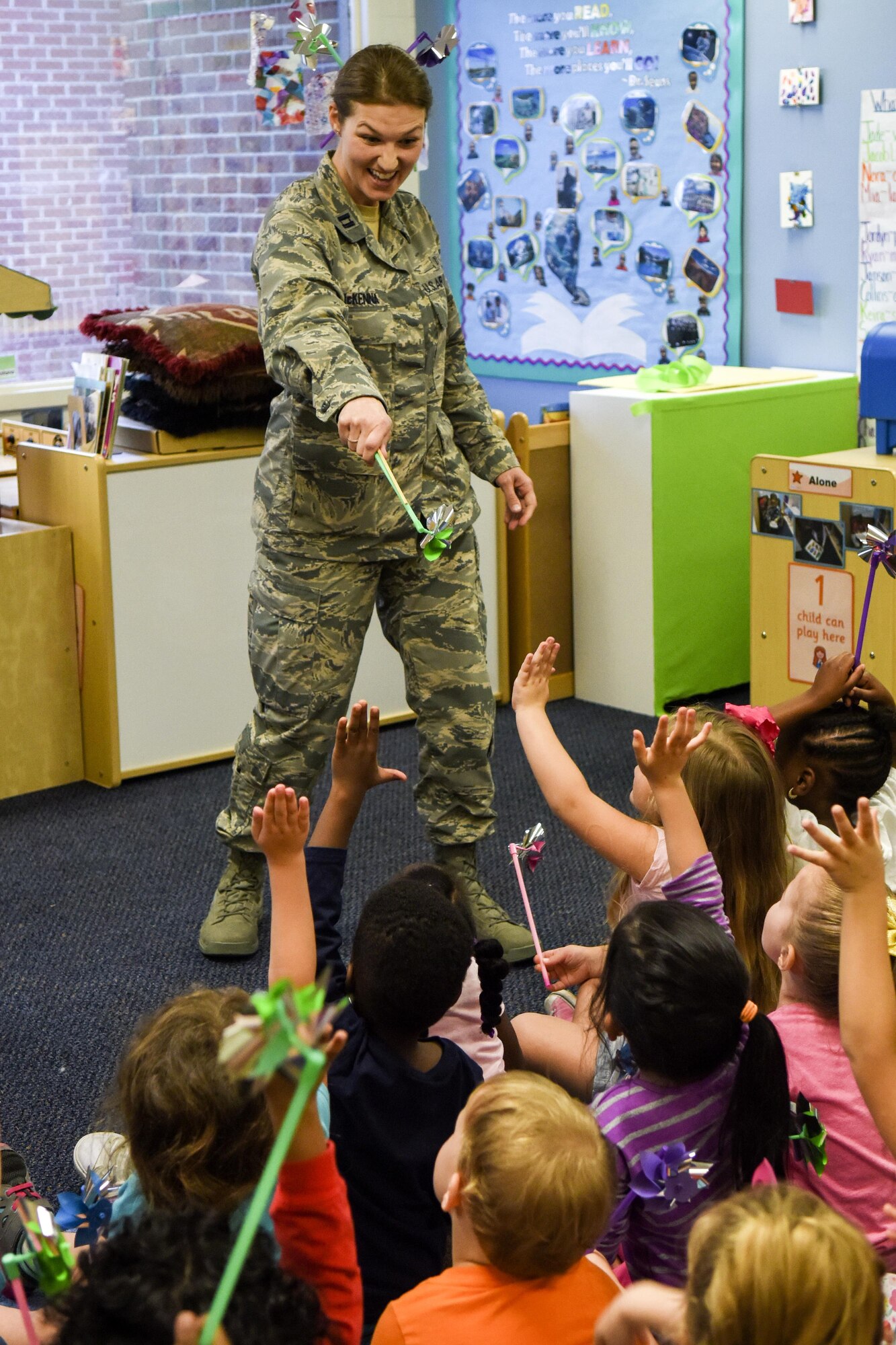 Capt. Kimberly McKenna, 4th Medical Operations Squadron Family Advocacy officer and social worker, tells children of Team Seymour about the symbol of the pinwheel, April 1, 2016, at Seymour Johnson Air Force Base, North Carolina. April is recognized as Child Abuse Prevention Month and acknowledges the importance of families and communities working together to prevent child abuse and neglect. (U.S. Air Force photo/Airman Shawna L. Keyes)