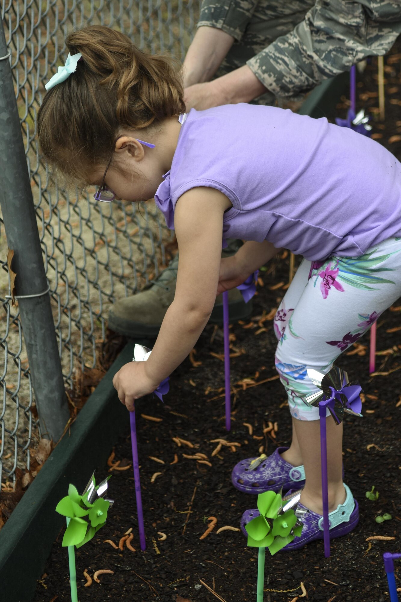 A child of Team Seymour plants a pinwheel during a “Pinwheels for Child Abuse Prevention” event, April 1, 2016, at Seymour Johnson Air Force Base, North Carolina. More than 40 children from the Child Development Center planted pinwheels in the back garden of the building. (U.S. Air Force photo/Airman Shawna L. Keyes)