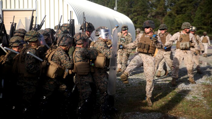 A riot control squad, comprised of Marines with Combat Logistics Battalion 2, battles a notional opposing force during the unit’s non-lethal weapons training final exercise at Marine Corps Base Camp Lejeune, North Carolina, March 25, 2016. The battalion had to qualify through the Expeditionary Operations Training Group, in preparation for their upcoming deployment with Special Purpose Marine Air-Ground Task Force-Crisis Response-Africa.