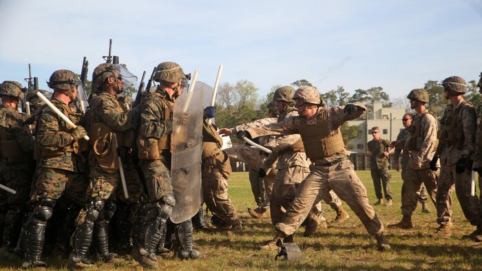 A riot control squad, comprised of Marines with Combat Logistics Battalion 2, confronts a notional opposing force during the unit’s non-lethal weapons training final exercise at Marine Corps Base Camp Lejeune, North Carolina, March 25, 2016. The battalion had to qualify through the Expeditionary Operations Training Group in preparation for their upcoming deployment with Special Purpose Marine Air-Ground Task Force-Crisis Response-Africa.