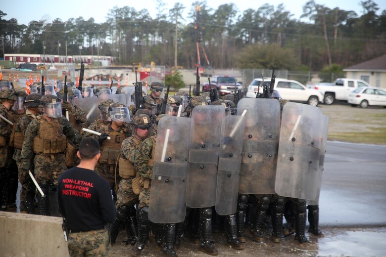 Marines with Combat Logistics Battalion 2 position themselves in a riot control formation during the unit’s non-lethal weapons training final exercise at Camp Lejeune, N.C., March 25, 2016. The battalion had to qualify through Expeditionary Operations Training Group in preparation for their upcoming deployment with Special Purpose Marine Air-Ground Task Force-Crisis Response- Africa. (U.S. Marine Corps photo by Cpl. Joey Mendez)