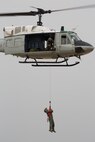 Airmen from the 459th Airlift Squadron perform a hoist demonstration at Yokota Air Base, Japan, March 30, 2016. The 459th AS introduced their airlift capabilities, which were the Aeromedical Evacuation operation with a C-12 Huron and search and rescue capabilities with a UH-1 Iroquois. (U.S. Air Force photo by Yasuo Osakabe/Released)