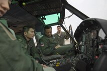 Japan Air Self-Defense members of the 402nd Squadron sit in a UH-1 Iroquois cockpit at Yokota Air Base, Japan, March 30, 2016, during a search and rescue demonstration for 402 SQ members. Members with the 459th AS introduced their airlift capabilities, which were the Aeromedical Evacuation operation with a C-12 Huron and search and rescue capabilities with a UH-1 Iroquois. (U.S. Air Force photo by Yasuo Osakabe/Released)