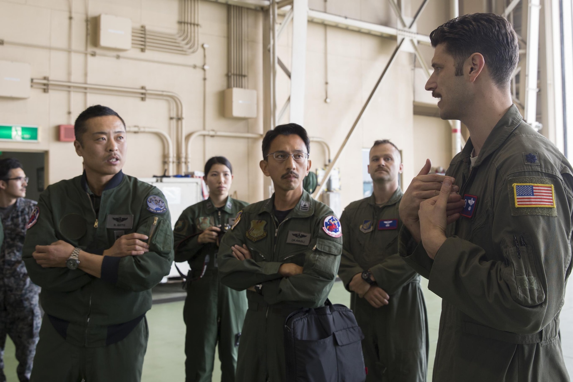 (Right to left) U.S. Air Force Lt. Col. William Marin, 459th Airlift Squadron commander, briefs Japan Air Self-Defense Force members of the 402nd Squadron, at Yokota Air Base, Japan, March 30, 2016. Members from the 459th AS demonstrated Aeromedical Evacuation procedures with a C-12 Huron to JASDF members to introduce AE operations and the AE Spectrum Bed. (U.S. Air Force photo by Yasuo Osakabe/Released)
