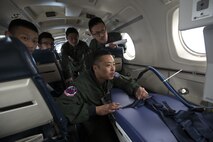 Japan Air Self-Defense Force Lt. Col. Ryoichi Goto, 402nd Squadron commander, checks an Aeromedical Evacuation Bed during an AE familiarization Flight on a C-12 Huron over Yokota Air Base, Japan, March 30, 2016. Members with the 459th AS demonstrated Aeromedical Evacuation procedures of a C-12 Huron to JASDF members to improve the working relationship between JASDF and USAF. (U.S. Air Force photo by Yasuo Osakabe/Released)