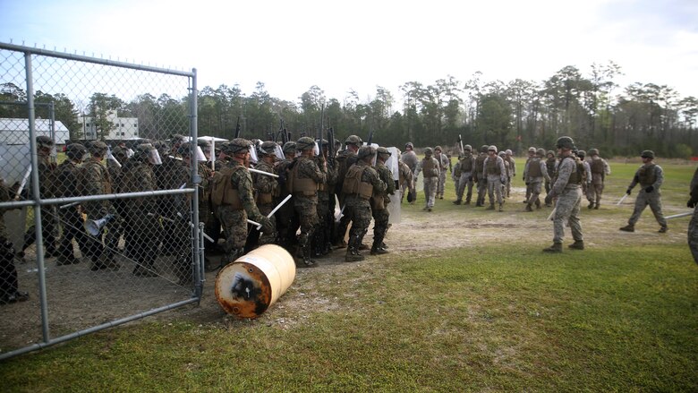 A riot control squad, comprised of Marines with Combat Logistics Battalion 2, faces a notional opposing force during the unit’s non-lethal weapons training final exercise at Camp Lejeune, N.C., March 25, 2016. The battalion had to qualify through the Expeditionary Operations Training Group in preparation for their upcoming deployment with Special Purpose Marine Air-Ground Task Force-Crisis Response-Africa. (U.S. Marine Corps photo by Cpl. Joey Mendez)