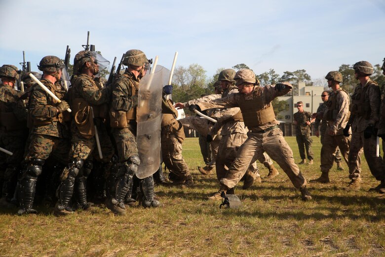 A riot control squad, comprised of Marines with Combat Logistics Battalion 2, confronts a notional opposing force during the unit’s non-lethal weapons training final exercise at Camp Lejeune, N.C., March 25, 2016. The battalion had to qualify through the Expeditionary Operations Training Group in preparation for their upcoming deployment with Special Purpose Marine Air-Ground Task Force-Crisis Response-Africa. (U.S. Marine Corps photo by Cpl. Joey Mendez)