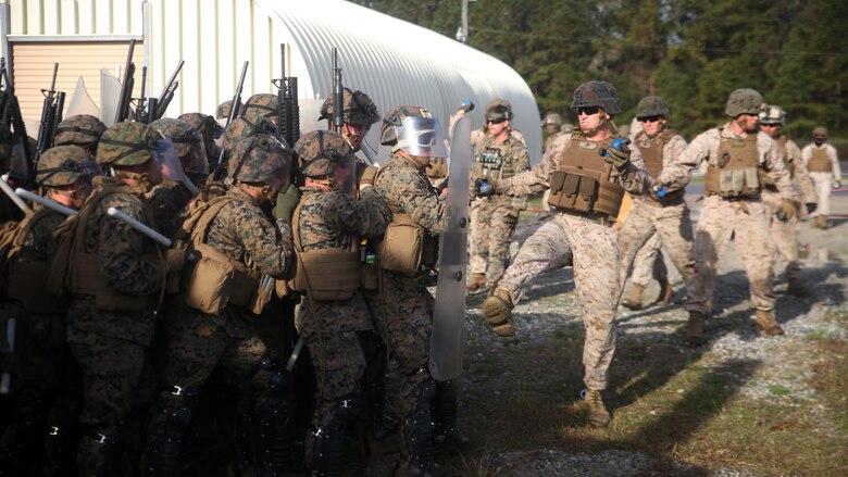A riot control squad, comprised of Marines with Combat Logistics Battalion 2, battles a notional opposing force during the unit’s non-lethal weapons training final exercise at Camp Lejeune, N.C., March 25, 2016. The battalion had to qualify through the Expeditionary Operations Training Group, in preparation for their upcoming deployment with Special Purpose Marine Air-Ground Task Force-Crisis Response-Africa. (U.S. Marine Corps photo by Cpl. Joey Mendez)