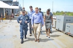 Cmdr. Ed Callahan, executive officer of the Emory S. Land-class submarine tender USS Frank Cable (AS 40), explains shipboard capabilities during a ship's tour to military legislative assistant Alec D. Johnson, March 30. Frank Cable, forward deployed to the island of Guam conducts maintenance and support of submarines and surface vessels deployed to the U.S. 7th Fleet area of responsibility.