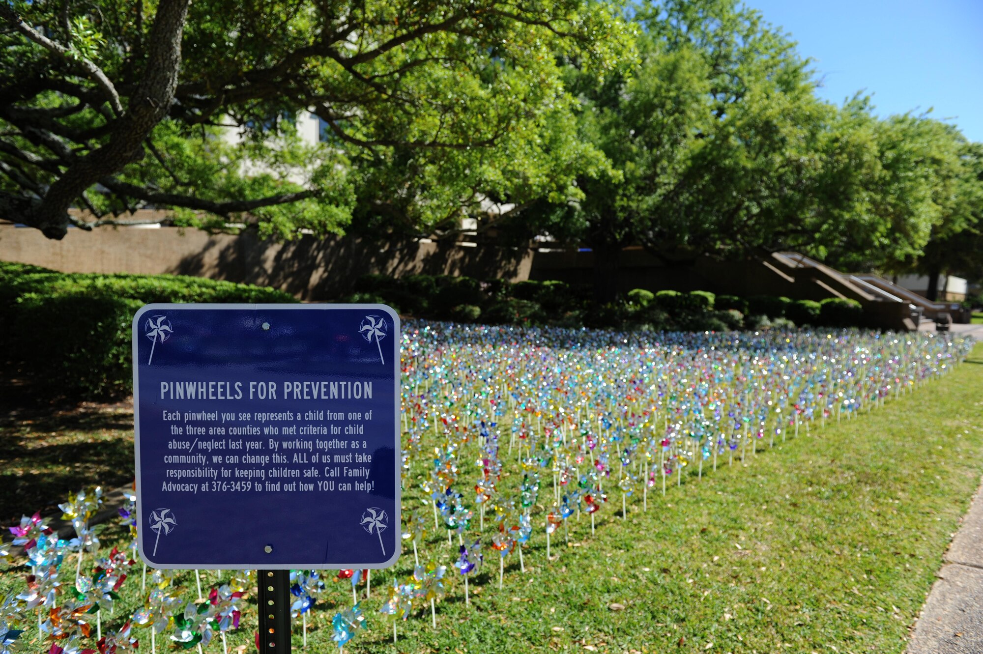 Pinwheels swirl in front of the Keesler Medical Center April 4, 2016, Keesler Air Force Base, Miss. Members of the 81st Medical Operations Squadron family advocacy and volunteers placed pinwheels to individually represent children in Harrison and Hancock counties who were victims of child abuse or neglect last year. (U.S. Air Force photo by Kemberly Groue)