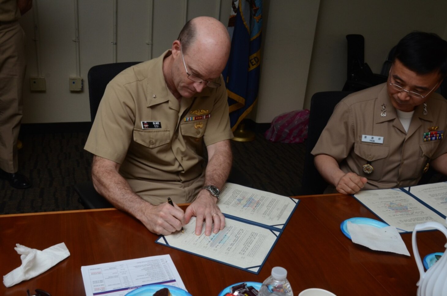 160331-N-YM720-263 SANTA RITA, Guam (March 31, 2016) Rear Adm. William Merz, commander, Submarine Group 7, left, and Rear Adm. Youn Jeong Sang, commander, Submarine Force, Republic of Korea Navy (ROKN), sign a formal agreement at the conclusion of the 43rd Submarine Warfare Committee Meeting (SWCM) reaffirming the longstanding relationship between the two countries and pledging continued support between the two submarine forces. SWCM is a bilateral discussion between the U.S. and ROKN submarine forces designed to foster the partnership and focuses on submarine tactics, force integraton and future submarine development. (U.S. Navy photo by MC3 Allen McNair/Released)