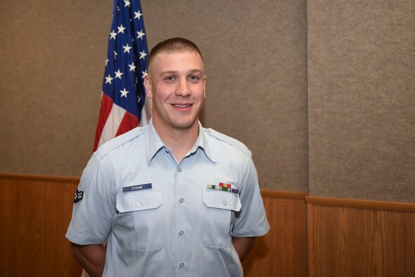 U.S. Air Force Airman 1st Class Michael Strand, 315th Training Squadron student, smiles for a portrait in Brandenburg Hall on Goodfellow Air Force Base, Texas, April 1, 2016. Strand is the Goodfellow Student of the Month spotlight for March, a series highlighting Team Goodfellow students. (U.S. Air Force photo by Airman Chase Sousa/Released)