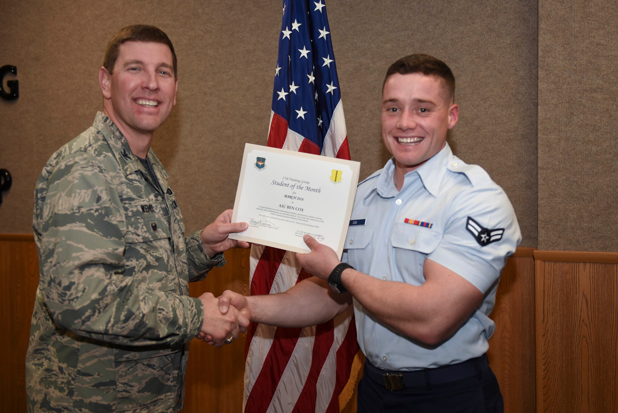 U.S. Air Force Col. Kurt A. Wendt, 17th Training Group Deputy Commander, presents the 312th Training Squadron Enlisted Student of the Month award for March 2016 to Airman 1st Class Ben Cox at the Brandenburg Hall on Goodfellow Air Force Base, Texas, April 1, 2016. (U.S. Air Force photo by Airman Chase Sousa/Released)