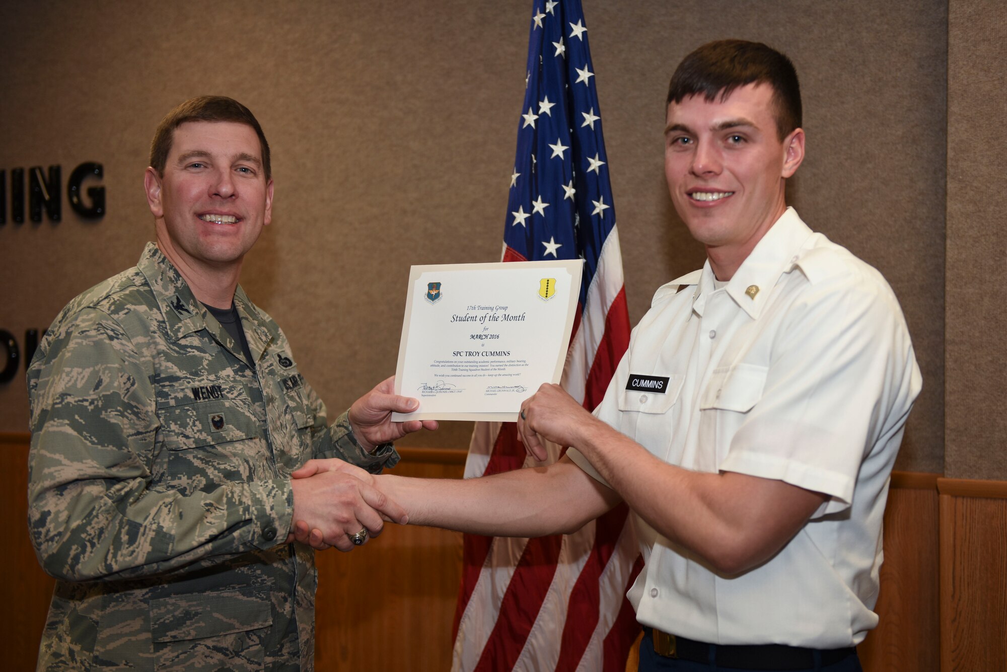 U.S. Air Force Col. Kurt A. Wendt, 17th Training Group Deputy Commander, presents the 316th Training Squadron Enlisted Student of the Month award for March 2016 to U.S. Army Spc. Troy Cummins at the Brandenburg Hall on Goodfellow Air Force Base, Texas, April 1, 2016. (U.S. Air Force photo by Airman Chase Sousa/Released)