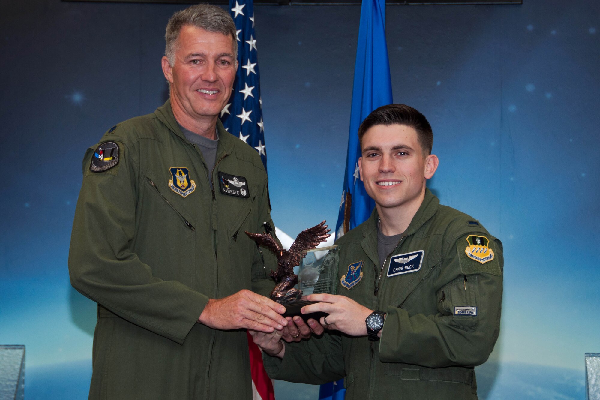U.S. Air Force Lt. Col. Robert Van Hoy, 93rd Bomb Squadron commander, presents the Lindell Mabus Leadership Award to 1st Lt. Chris Beck during a Formal Training Unit graduation ceremony, April 1, 2016, Barksdale Air Force Base, La. Beck was selected by his fellow class members for his exceptional leadership, which was critical to the class's graduation. (U.S. Air Force photo by Master Sgt. Laura Siebert /Released)