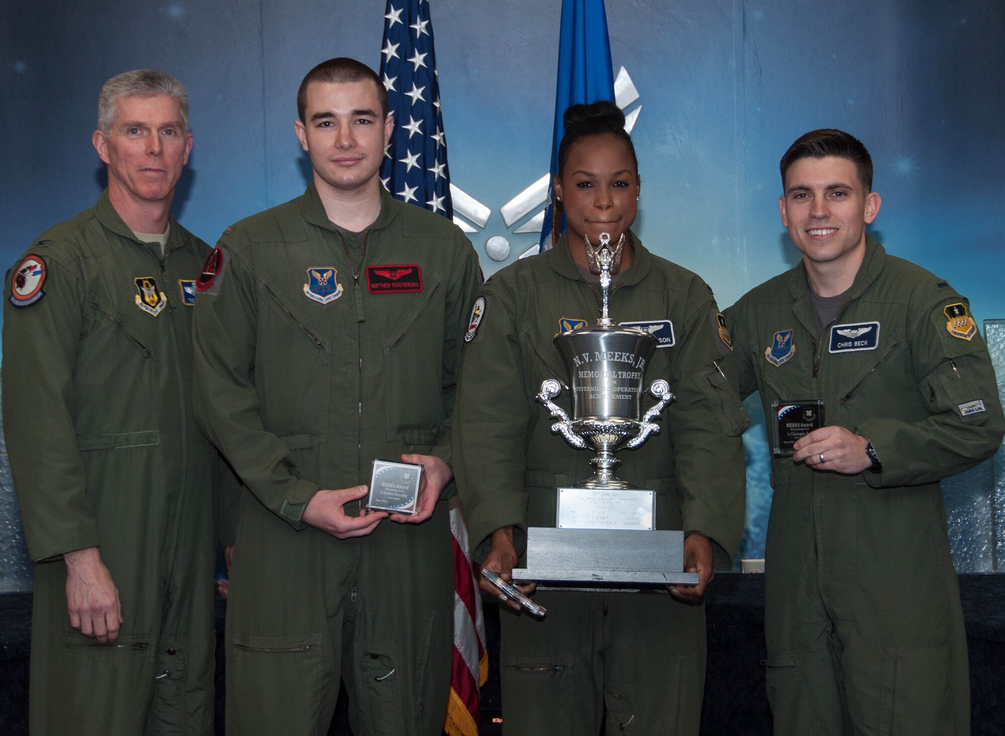U.S. Air Force, Col. James Morriss, vice wing commander of the 307th Bomb Wing, presents the Meeks Outstanding Crew Award to crew TUFF 33 during a Formal Training Unit graduation ceremony, April 1, 2016, Barksdale Air Force Base, La. The award is presented to the student aircrew that performs the best throughout the flight line phase of training. The crew members of TUFF 33 are; Weapon Systems Officer– 2nd  Lt. Matt Oostenburg, Electronic Warfare Officer –1st  Lt. Austyn Wilson and Pilot – 1st Lt. Chris Beck, (U.S. Air Force photo by Master Sgt. Laura Siebert /Released)