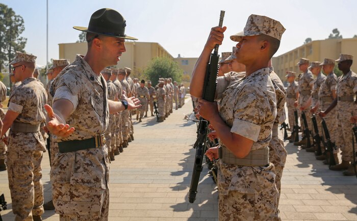 Staff Sgt. Edward T. Thiroux, drill instructor, Kilo Company, 3rd Recruit Training Battalion, quizzes a recruit on his knowledge during a series commander inspection at Marine Corps Recruit Depot San Diego, April 4. Drill instructors test recruits to see how much knowledge they’ve retained this far in training. Annually, more than 17,000 males recruited from the Western Recruiting Region are trained at MCRD San Diego. Kilo Company is scheduled to graduate May 6.