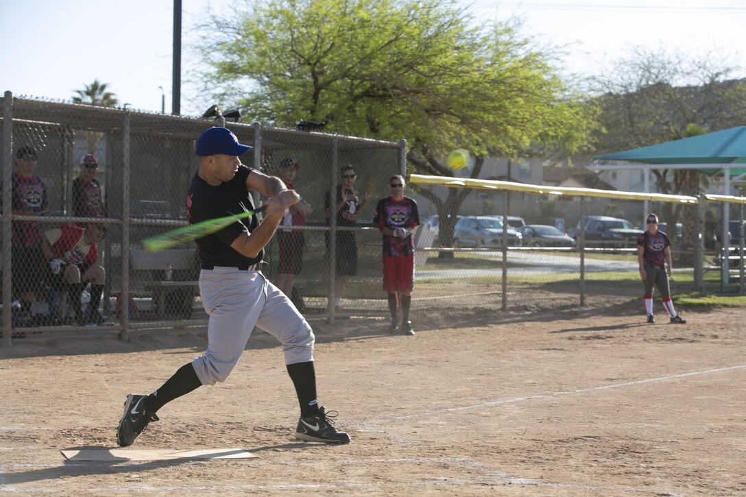 Master Sgt. Fernando Andrade, instructor, Marine Corps Communication-Electronics School, hits a softball during the Marine Corps Tactics and Operations Group annual Softball Tournament held at Felix Field, March 26, 2016. (Official Marine Corps photo by Cpl. Medina Ayala-Lo/ Released)