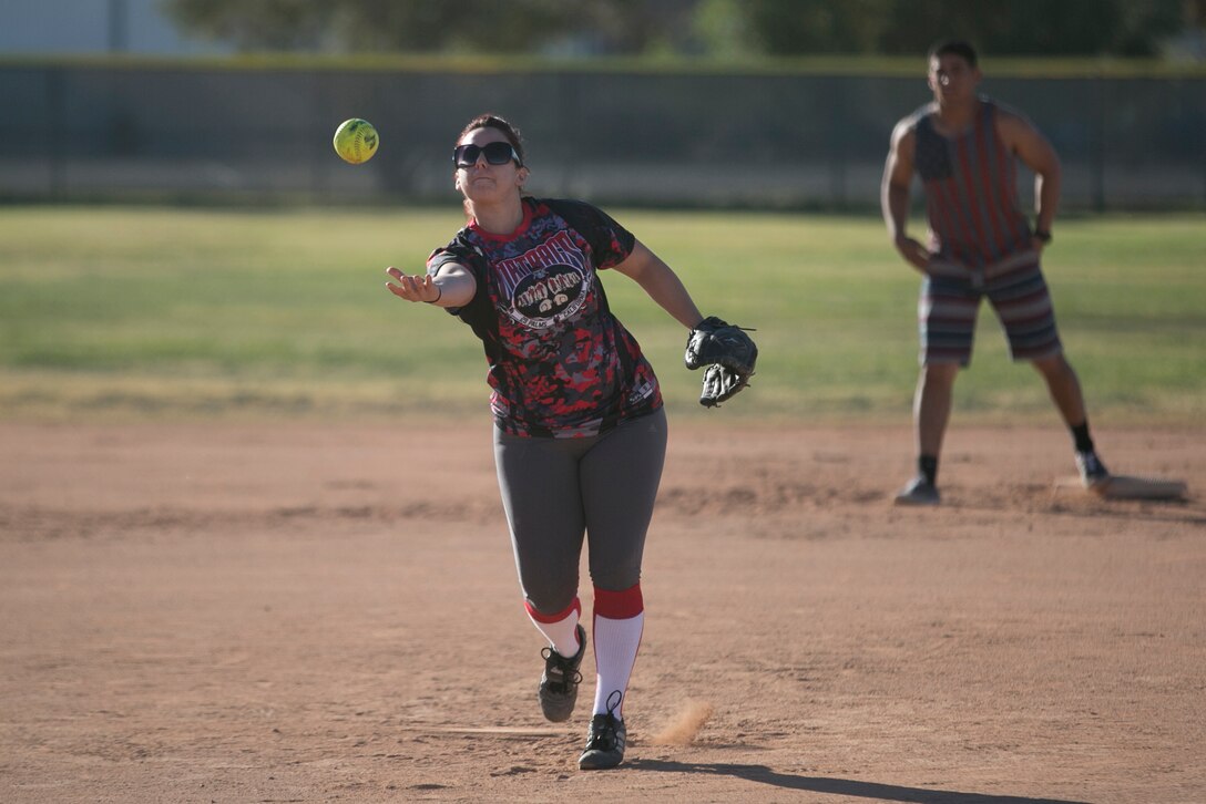 Staff Sgt. ShannonLee Martinez, instructor, Marine Corps Communication-Electronics School, pitches a softball during the Marine Corps Tactics and Operations Group annual Softball Tournament held at Felix Field, March 26, 2016. (Official Marine Corps photo by Cpl. Medina Ayala-Lo/ Released)