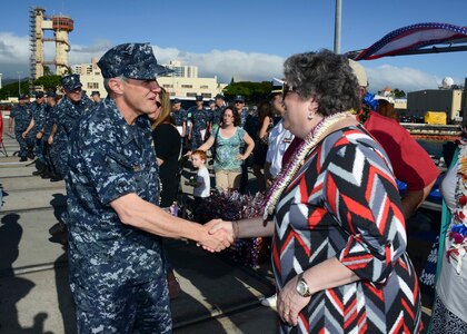 PEARL HARBOR (Nov. 25, 2014) Rear Adm. Phil Sawyer, commander of Submarine Force, U.S. Pacific Fleet, greets Allison Stiller, deputy assistant secretary of the Navy for ship programs and ship sponsor of the Virginia-class attack submarine USS Mississippi (SSN 782), during an arrival ceremony as Mississippi is welcomed to its new homeport at Joint Base Pearl Harbor-Hickam. Mississippi is the 4th Virginia-class submarine to be home ported in Pearl Harbor, and one of 18 attack submarines permanently homeported at the historic base. (U.S. Navy photo by Mass Communication Specialist 1st Class Steven Khor/Released) 