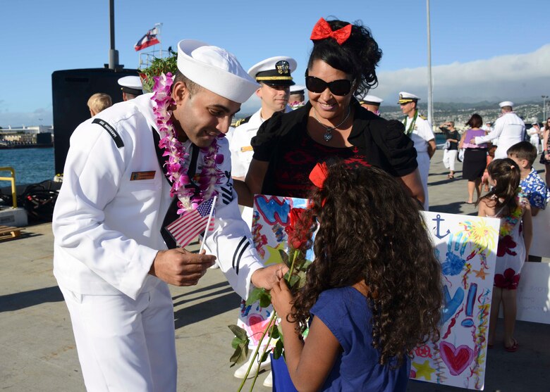 141125-N-DB801-293 PEARL HARBOR (Nov. 25, 2014) Machinist's Mate 1st Class Luis Navarrodiaz, assigned to the Virginia-class attack submarine USS Mississippi (SSN 782), greets his daughter wife and daughter as the submarine arrives at Joint Base Pearl Harbor-Hickam for a change of homeport from Commander, Submarine Squadron (SUBRON) 4 in Groton, Conn., to SUBRON-1. Mississippi is the 4th Virginia-class submarine to be home ported in Pearl Harbor, and one of 18 attack submarines permanently homeported at the historic base. (U.S. Navy photo by Mass Communication Specialist 1st Class Steven Khor/Released) 