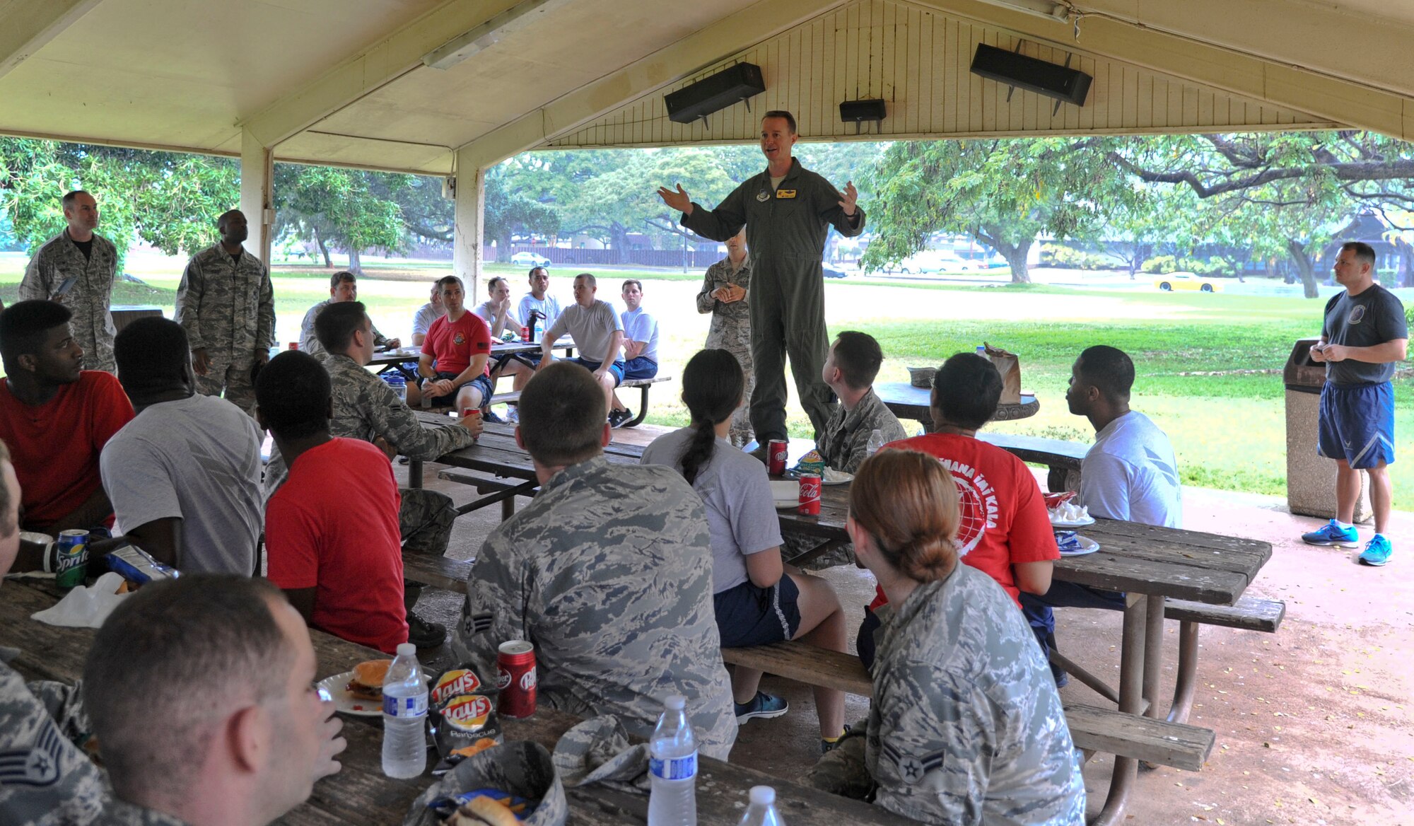 Col. Randy Huiss, 15th Wing commander, speaks to a crowd of Airmen after the base-wide cleanup on Joint Base Pearl Harbor-Hickam, Hawaii, March 25, 2015. More than 200 Airmen volunteered to take part in the massive Hickam Field Cleanup, which was intended to encourage pride and ownership as well as beautify the base. (U.S. Air Force photo by Tech. Sgt. Terri Paden)