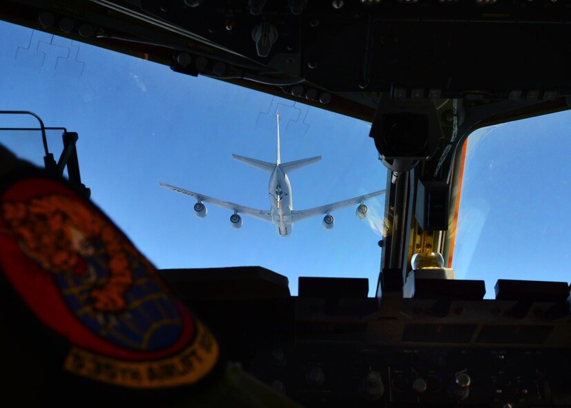 Captain Ryan Troxel, a pilot from the 535th Airlift Squadron, positions a C-17 Globmaster III to receive fuel from a KC-135 Stratotanker, from the 203rd Air Refueling Squadron, near Joint Base Pearl Harbor-Hicakm, March 31, 2016. (U.S. Air Force photo by Tech. Sgt. Aaron Oelrich/released) 