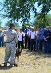 Staff Sgt. Robert Overfelt, a 647th Security Forces Squadron military working dog handler, describes his relationship with Miltary Working Dog Norman to the Friends of Hickam during a tour of Joint Baser Pearl Harbor-Hickam, March 31, 2016. The tour highlighted some of the 15th Wings agencies including Security Forces, Explosive Ordines Disposal, Maintenances and the 15th Medical Group. The Friends of Hickam serve as facilitators between the 15th Wing command and the Hawaii community. The purpose of the Friends of Hickam is to provide public support for the U.S. Air Force in Hawaii and its missions. They also help to improve the quality of life for Air Force personnel and their families. (U.S. Air Force photo by Tech. Sgt. Aaron Oelrich/released) 