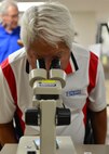 Pat Chun, president of the Friends of Hickam, looks at mosquito larvae during a tour of the 15th Medical Group on Joint Base Pearl Harbor-Hickam, March 31, 2016. The tour highlighted some of the 15th Wings agencies including Security Forces, Explosive Ordines Disposal, Maintenances and the 15th Medical Group. The Friends of Hickam serve as facilitators between the 15th Wing command and the Hawaii community. The purpose of the Friends of Hickam is to provide public support for the U.S. Air Force in Hawaii and its missions. They also help to improve the quality of life for Air Force personnel and their families. (U.S. Air Force photo by Tech. Sgt. Aaron Oelrich/released) 