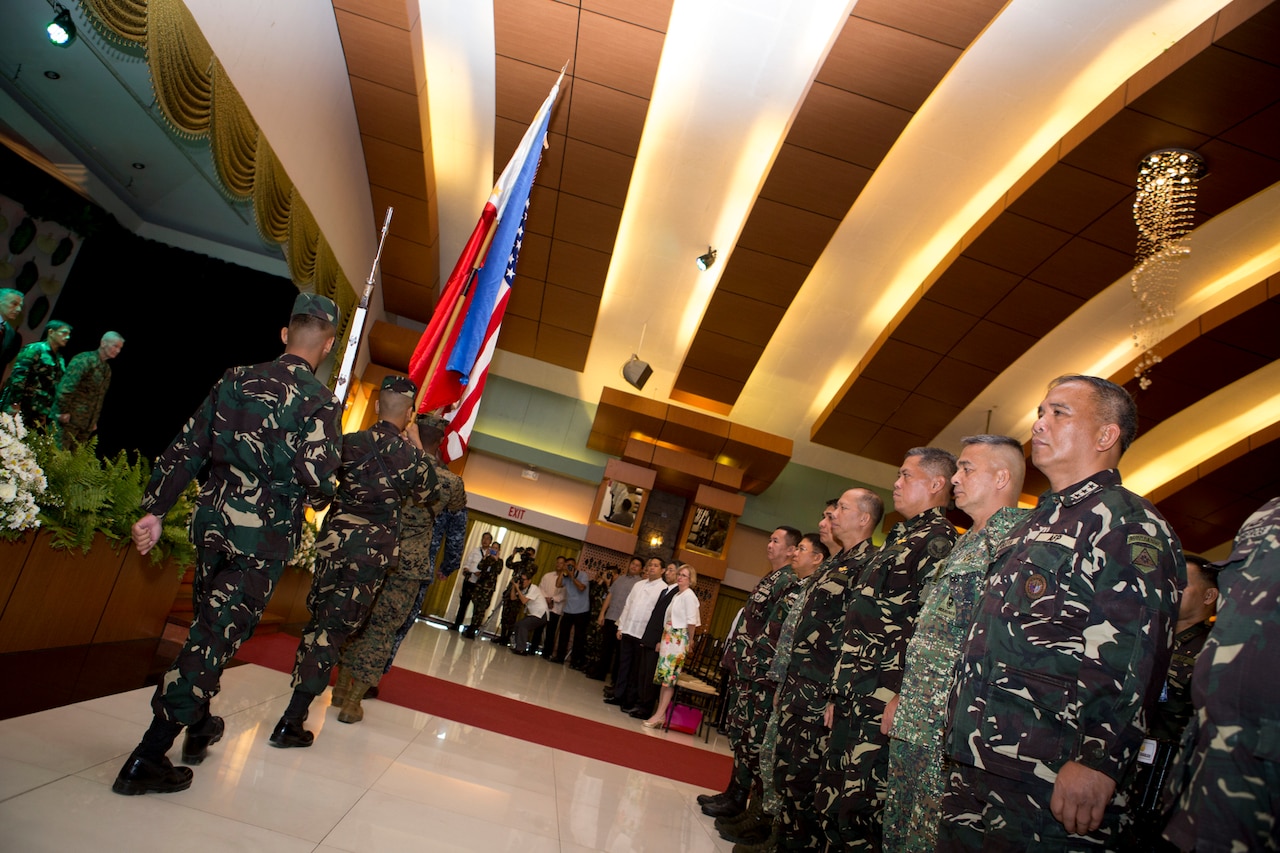 Flags from both nations are retired, during the opening ceremony of Balikatan 2016, aboard Camp Aguinaldo, April 4, 2016. Balikatan, which means "shoulder to shoulder" in Filipino, is an annual bilateral training exercise focused on improving the ability of Philippine and U.S. military forces to work together during planning, contingency and humanitarian assistance and disaster relief operations. This year marks the 32nd iteration of the exercise. 