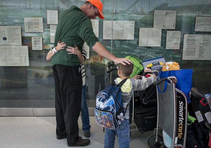 Retired Lt. Col. Michael Needham surprises his niece, Megan Croot and her children when they arrived at Baltimore Washington International Airport, Md., April 1, 2016. Defense Department dependents in Adana, Izmir and Mugla, Turkey, were given an ordered departure by the State Department and Secretary of Defense. (U.S. Air Force photo/Staff Sgt. Andrew Lee)

