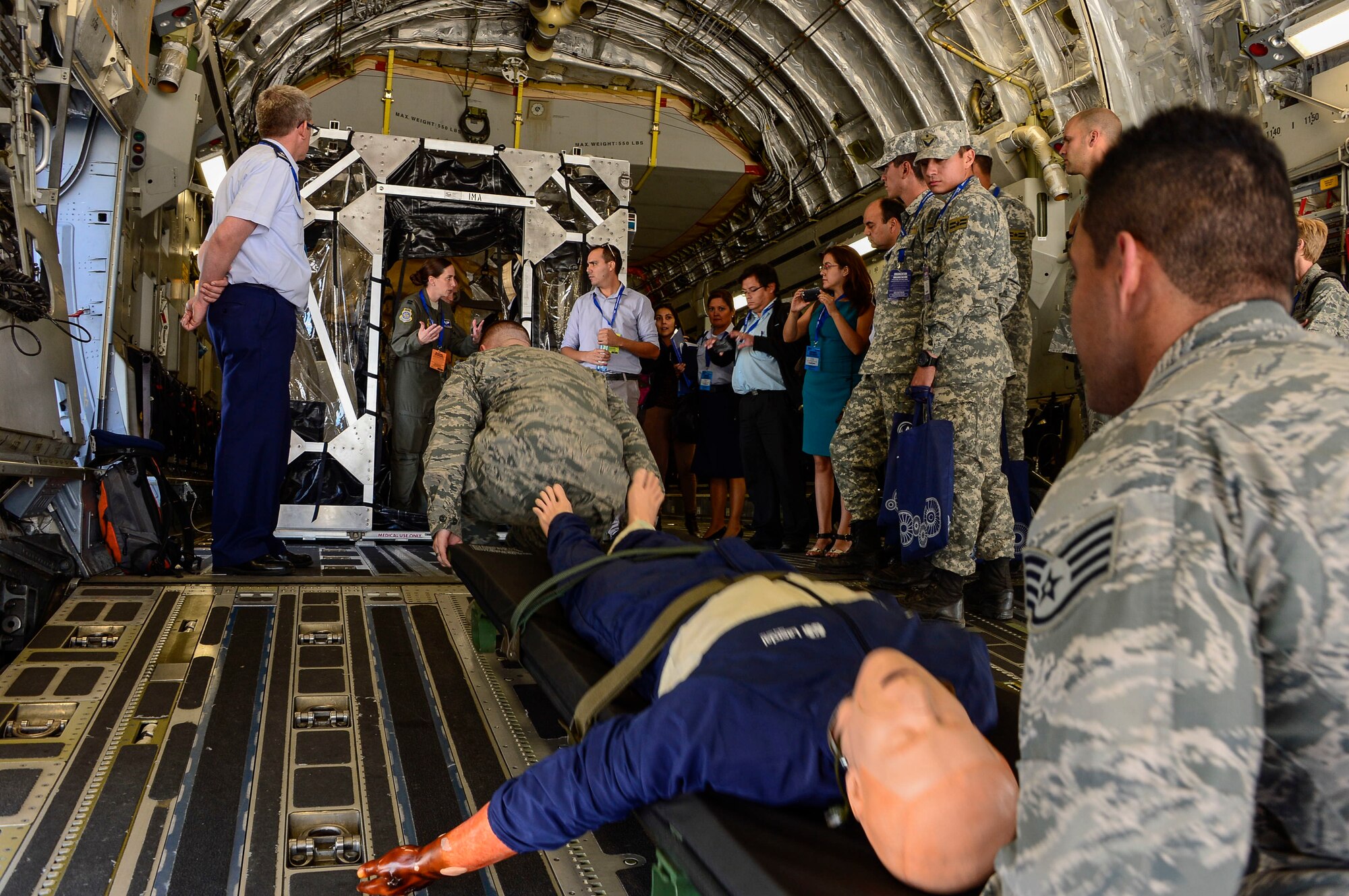 Capt. William Matthews and Staff Sgt. Adam Ruiz, bio-environmental engineers from Charleston Air Force Base, South Carolina, demonstrate how to load casualties into the Transport Isolation System during a subject matter expert exchange at the 2016 FIDAE Air and Space Trade Show in Santiago, Chile, March 29, 2016. Exchanges are conducted regularly throughout the year and involve U.S. Airmen sharing best practices and procedures to build partnerships and promote interoperability with partner-nation air forces throughout South America, Central America and the Caribbean. (U.S. Air Force photo by Tech. Sgt. Heather Redman/Released)