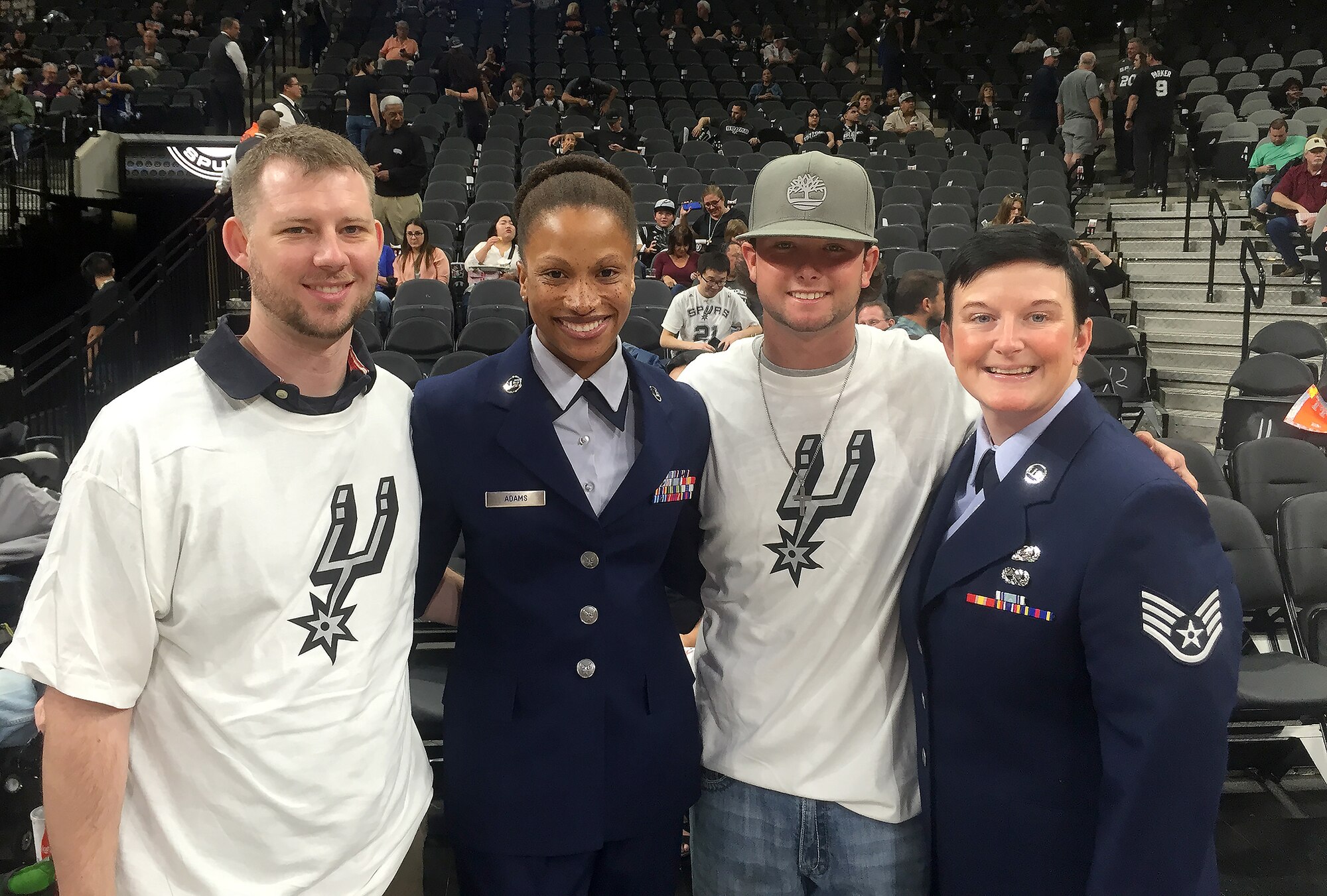 (from left) Ryan Adams, Staff Sgt. Lin Adams, Jayme Kidder, and Staff Sgt. Roberta Kidder pose for a photo during pre-game at the San Antonio Spurs game March 30, 2016 at the At&t Center. Kidder and Adams were selected by 433rd Airlift Wing leadership for their exceptional performance in their work sections. (U.S. Air Force photo by SSgt. Roberta Kidder) (released)
