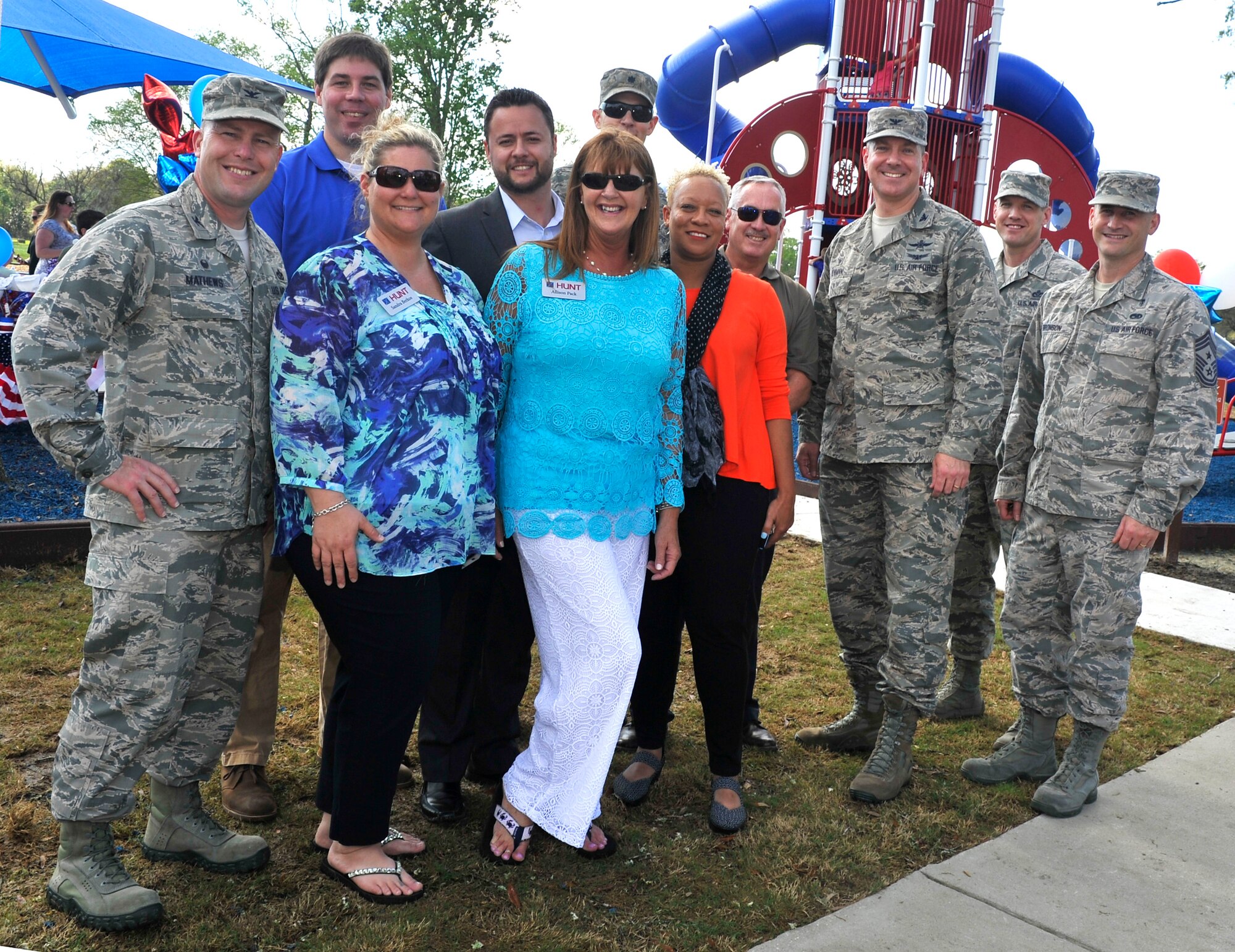Leadership from Joint Base Charleston and Hunt Companies pose for a group photo after a ribbon cutting ceremony to open the new playground, on Touhey Boulevard, at JB Charleston March 28, 2016. The playground benefits parents by giving them a place to relax and talk to other parents while their kids play. (U.S. Air Force photo/Airman Megan Munoz)