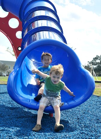 Kids from the Joint Base Charleston community play on the slide in JB Charleston’s new playground March 28, 2016. The playground, on Touhey Boulevard, provides space for children to play without having to cross busy streets. (U.S. Air Force photo/Airman Megan Munoz)