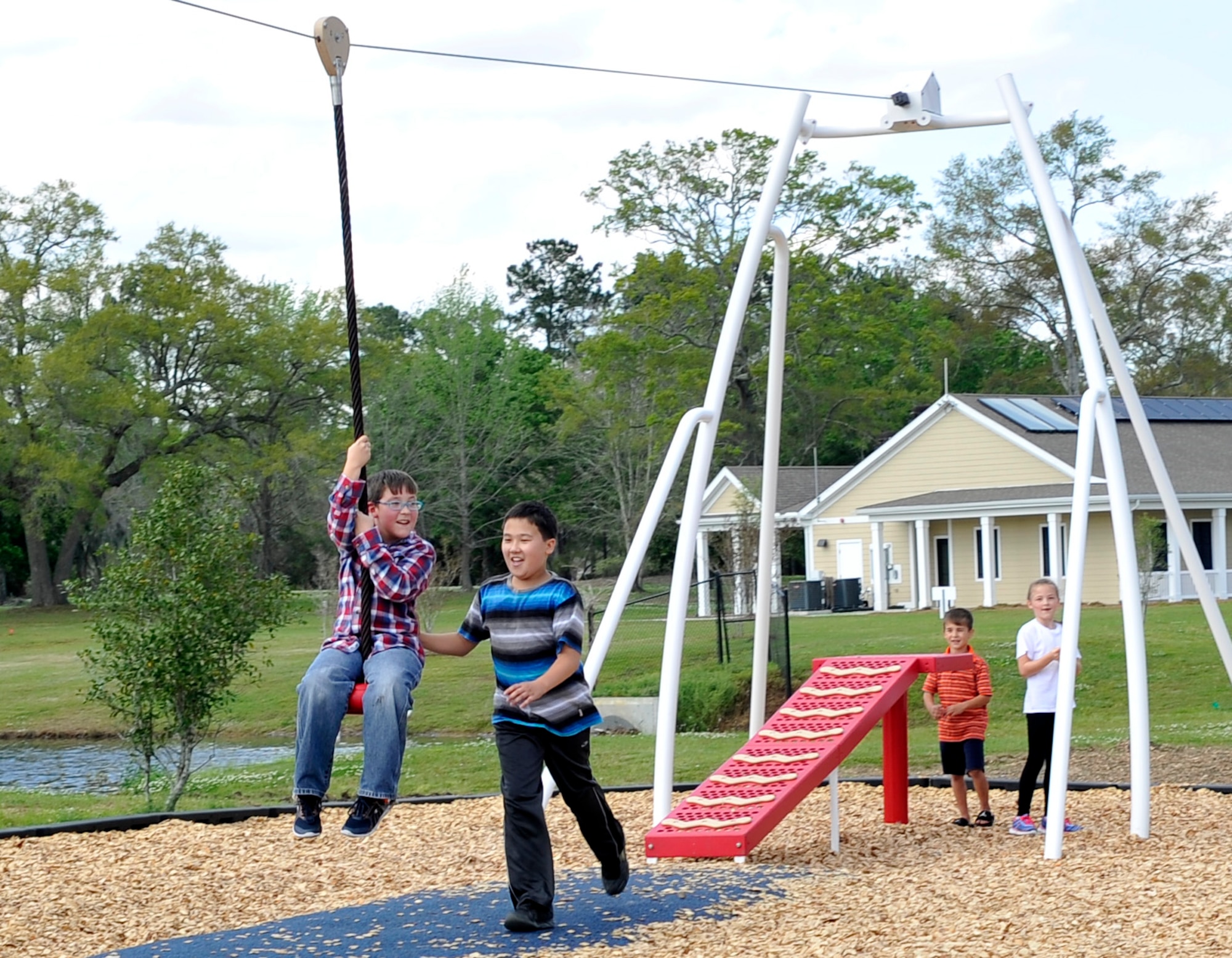 Kids from the Joint Base Charleston community use the zip line in JB Charleston’s new playground, on Touhey Boulevard, March 28, 2016. The playground is open to base residents every day from 8 a.m. to sunset. (U.S. Air Force photo/Airman Megan Munoz)