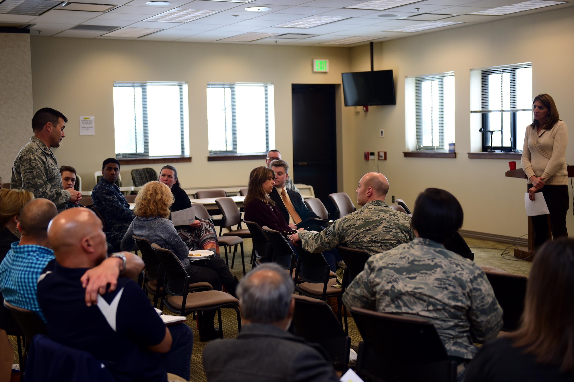 Col. John Wagner, 460th Space Wing commander, and Christina Grooms, 460th Space Wing community support coordinator, discuss various based topics March 28, 2016, during a Caring for People forum at the Chapel on Buckley Air Force Base, Colo. The forum gave Team Buckley members a chance to express concerns affecting the military and civilian communities. (U.S. Air Force photo by Airman 1st Class Gabrielle Spradling/Released)