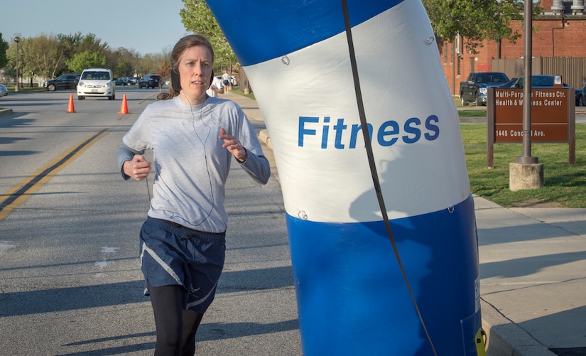 Col. Julie Grundahl, 11th Wing/Joint Base Andrews vice commander, crosses the finish line at the second annual “Consent to Color” 5k on Joint Base Andrews, Md., April 4, 2016. Grundahl was the first female finisher with a time of 25 minutes and 22 seconds. (U.S. Air Force photo by Senior Airman Ryan J. Sonnier/RELEASED)