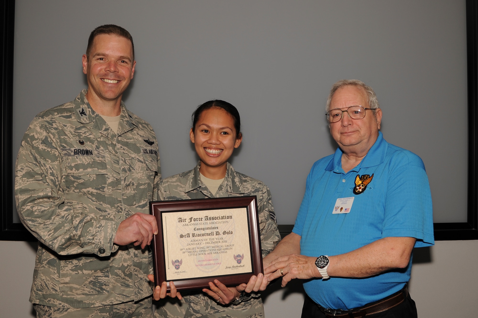 U.S. Air Force Col. Charles Brown, left, 19th Airlift Wing commander, and Jerry Reichenbach, right, AFA Arkansas state and the David D. Terry chapter president, congratulate Senior Airman Riocornell Golo, center, 19th Medical Operations Squadron pediatric medical technician, as the 2015 Air Force Association Airman of the Year for the 19th AW. The AFA has recognized top performers working throughout the Air Force for 70 years. (U.S. Air Force photo by Senior Airman Harry Brexel) 
